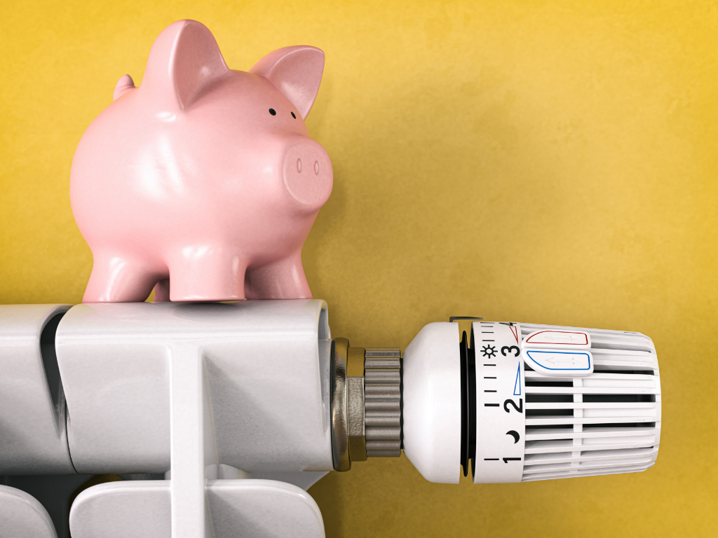 Piggy bank on radiator. Concept lower Energy cost